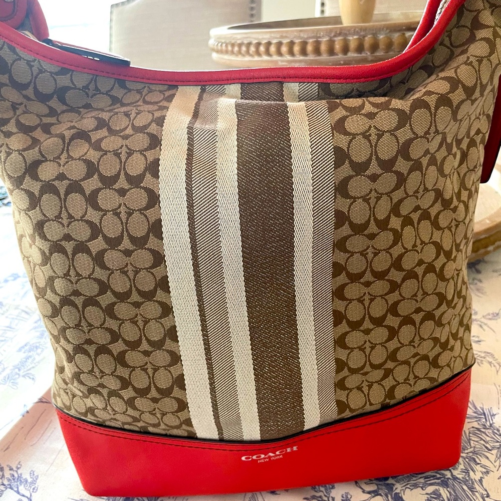 Coach signature shoulder bag - coral leather with signature brown/cream pattern.